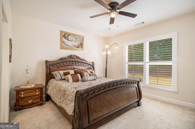 carpeted bedroom with ceiling fan and multiple windows