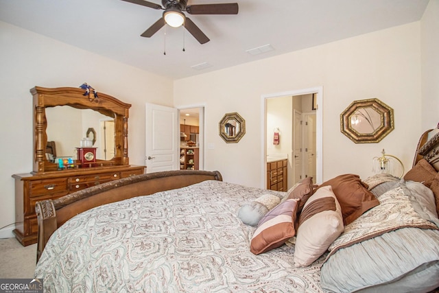 bedroom featuring ensuite bathroom, ceiling fan, and light colored carpet