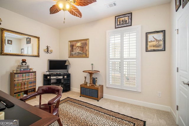 carpeted home office with ceiling fan