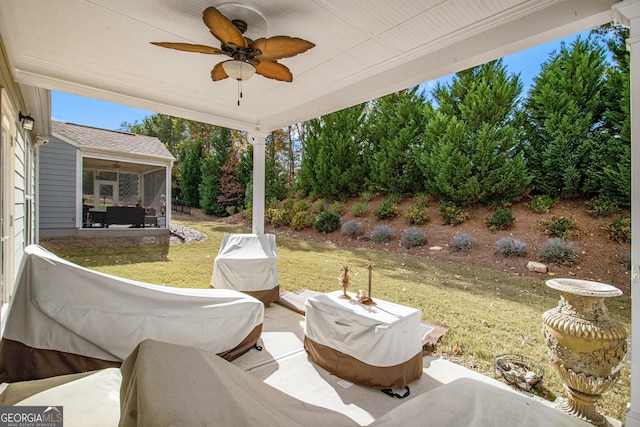 view of patio / terrace with a sunroom and ceiling fan