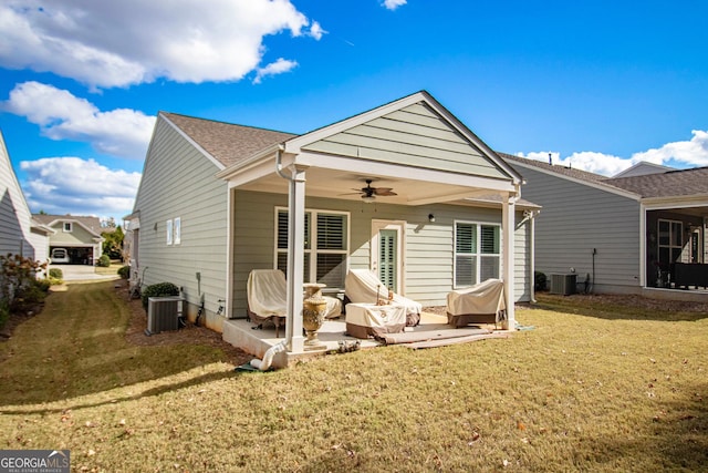 rear view of property with a lawn, ceiling fan, cooling unit, and a patio