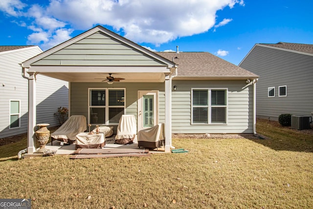 back of property with a lawn, ceiling fan, a patio area, and central AC