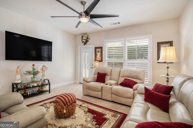 carpeted living room with ceiling fan