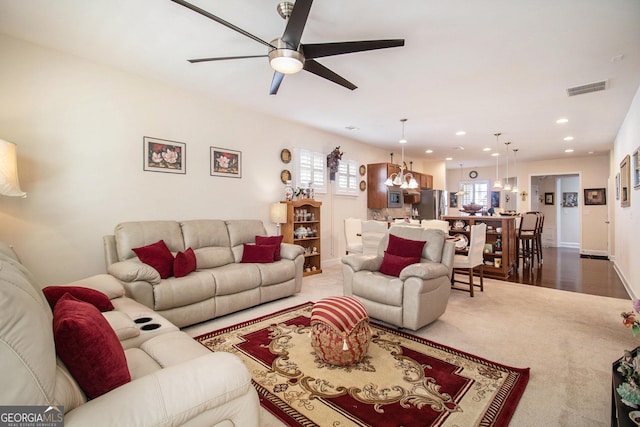 living room with ceiling fan and carpet floors