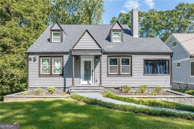 new england style home featuring a front yard