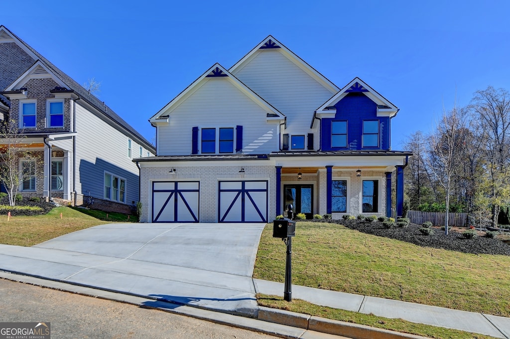 craftsman-style home with a front yard and a garage