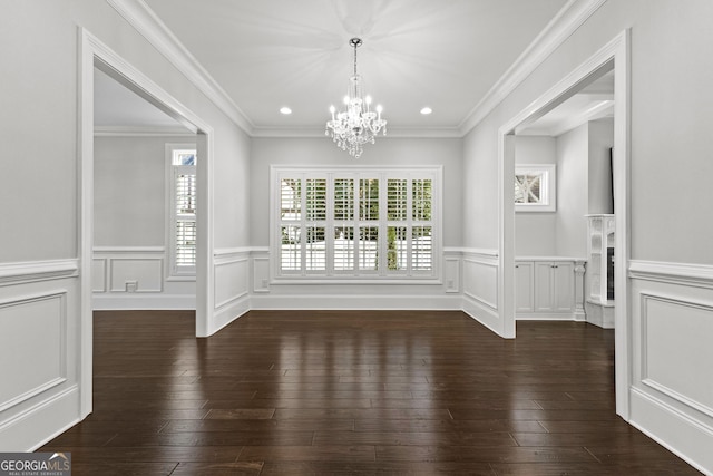 unfurnished dining area featuring a chandelier, dark hardwood / wood-style flooring, and crown molding