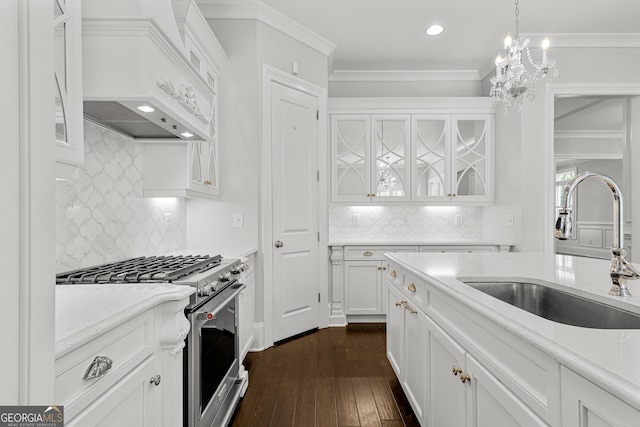 kitchen featuring stainless steel range, sink, dark hardwood / wood-style flooring, white cabinets, and custom exhaust hood