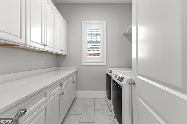 laundry room with cabinets and independent washer and dryer