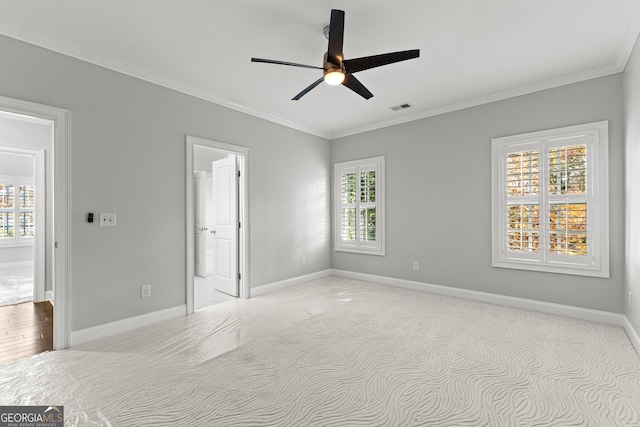 unfurnished room with ceiling fan, a healthy amount of sunlight, and ornamental molding