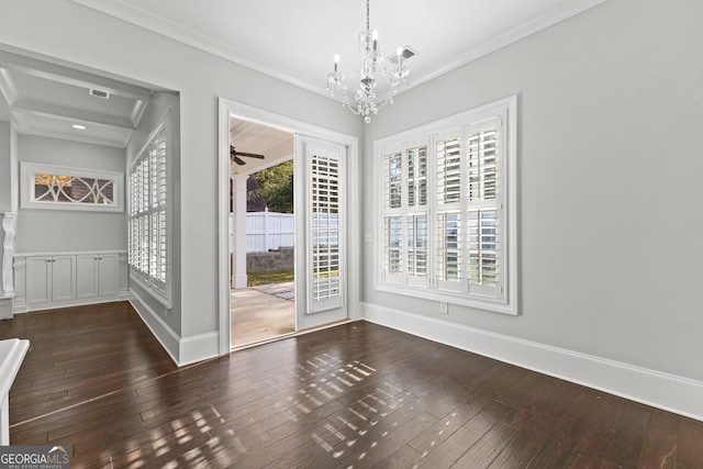 empty room featuring ceiling fan with notable chandelier, ornamental molding, and dark wood-type flooring