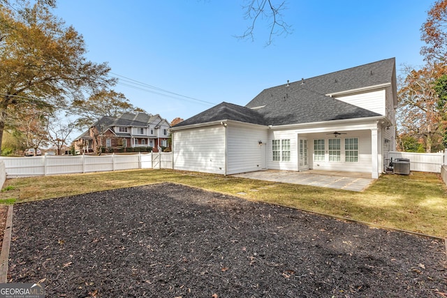 rear view of house featuring a lawn, ceiling fan, cooling unit, and a patio