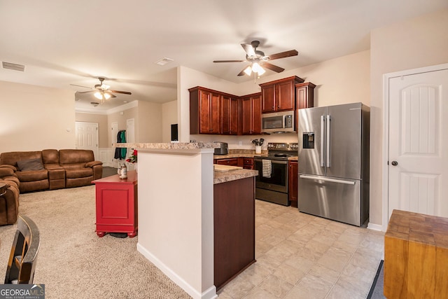 kitchen with kitchen peninsula, appliances with stainless steel finishes, light carpet, and ceiling fan