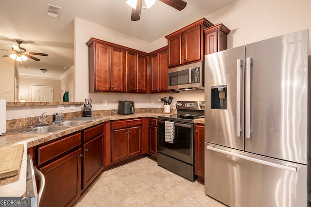 kitchen with crown molding, ceiling fan, sink, and stainless steel appliances