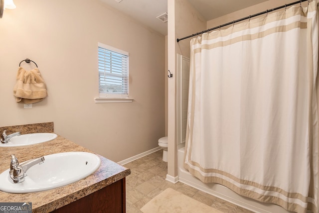 full bathroom featuring shower / bath combo, vanity, and toilet