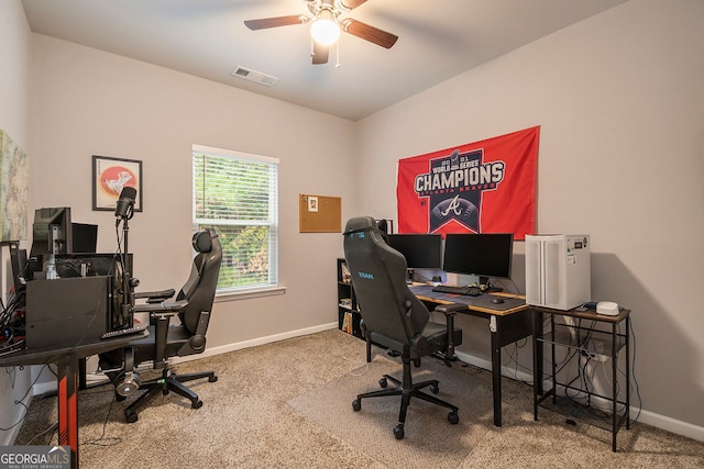 carpeted office space featuring ceiling fan