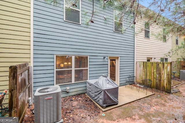 rear view of property featuring a patio and central AC