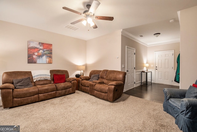 living room with ceiling fan, crown molding, and dark wood-type flooring