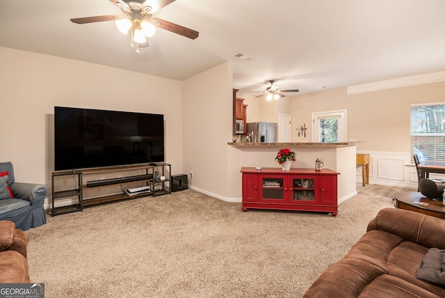 carpeted living room featuring ceiling fan