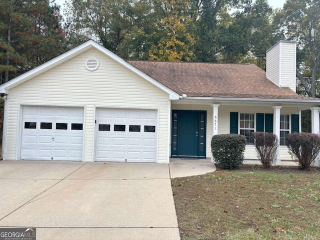 single story home with covered porch and a garage