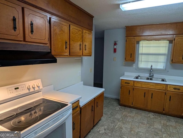 kitchen with white range with electric cooktop, sink, and a textured ceiling