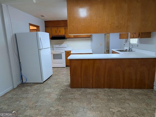 kitchen with kitchen peninsula, a textured ceiling, white appliances, and sink