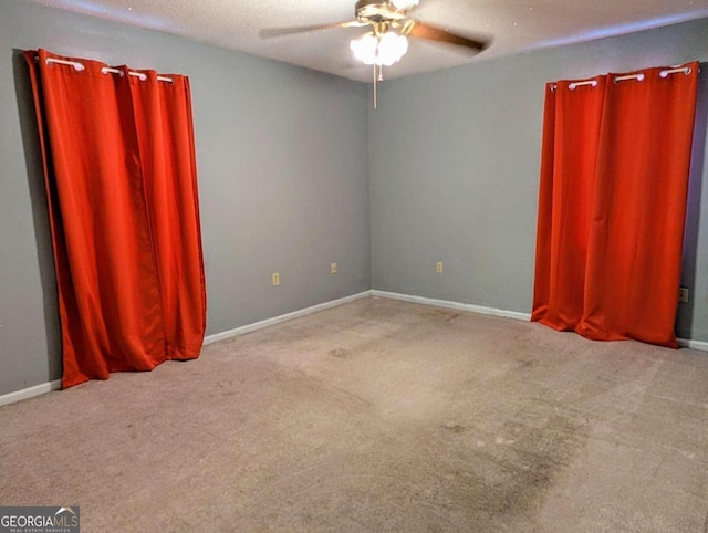 unfurnished room featuring a textured ceiling, light colored carpet, and ceiling fan