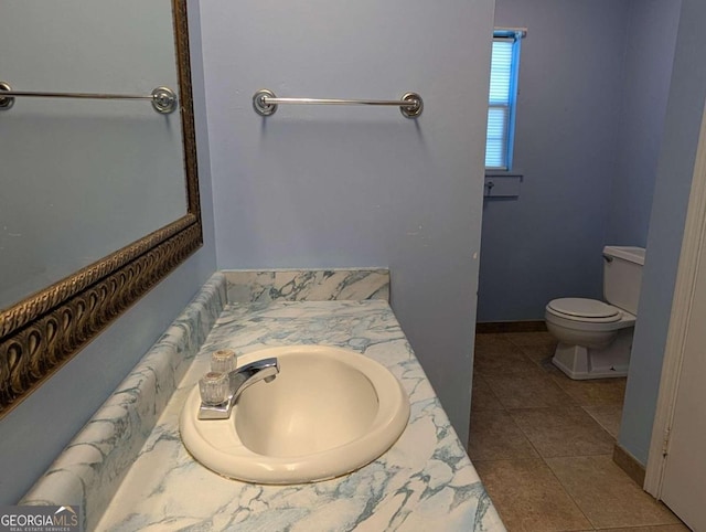 bathroom featuring tile patterned flooring, vanity, and toilet