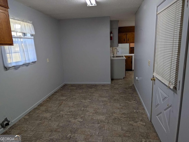 interior space featuring a textured ceiling and sink