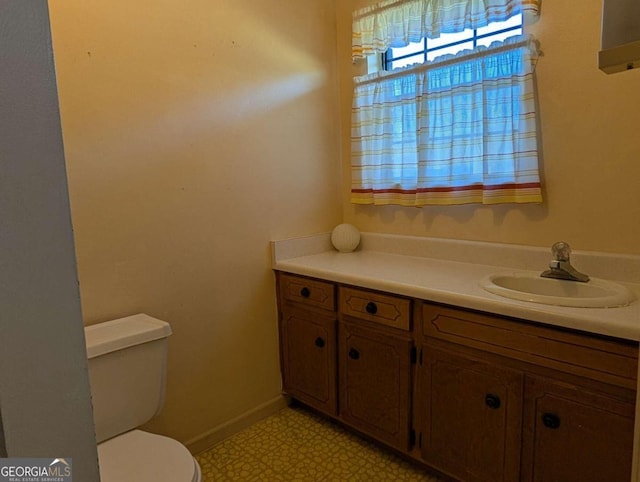 bathroom featuring vanity and toilet