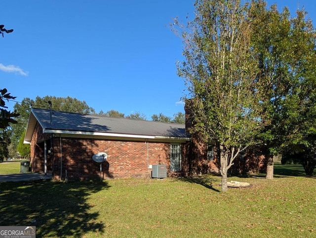 view of property exterior featuring a lawn and central AC unit