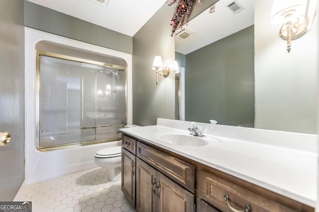 full bath featuring enclosed tub / shower combo, toilet, vanity, visible vents, and tile patterned floors