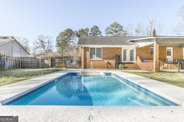 view of swimming pool featuring a fenced in pool, french doors, a fenced backyard, and a patio