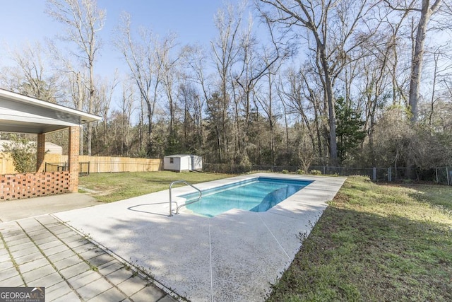 view of swimming pool with a patio, a shed, an outdoor structure, and a fenced backyard