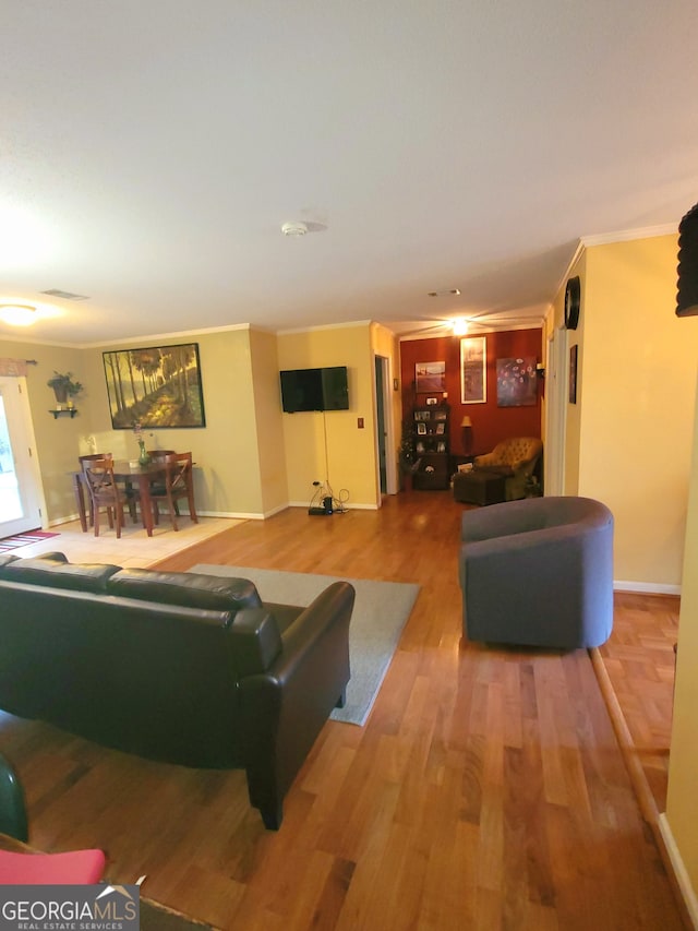 living room featuring hardwood / wood-style flooring and crown molding