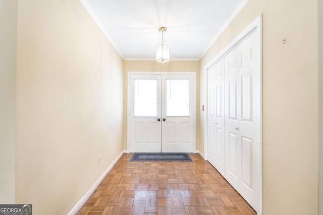 doorway with baseboards, crown molding, and french doors