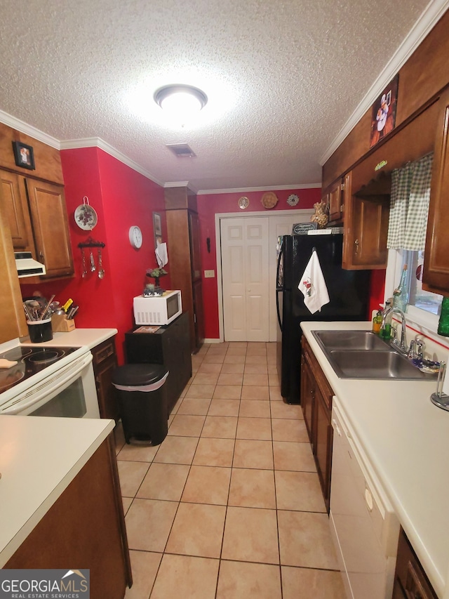 kitchen with ornamental molding, a textured ceiling, white appliances, sink, and light tile patterned floors