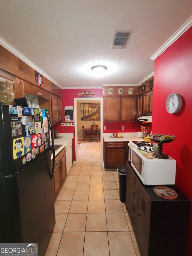 kitchen with a textured ceiling, white appliances, and ornamental molding