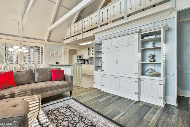 living room with dark hardwood / wood-style flooring, beamed ceiling, a chandelier, and high vaulted ceiling