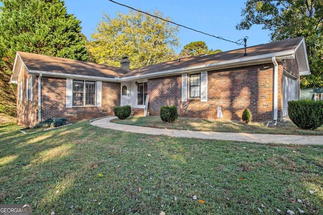 ranch-style home with a garage and a front lawn