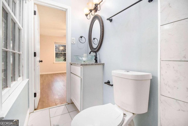 bathroom with hardwood / wood-style flooring, vanity, and toilet