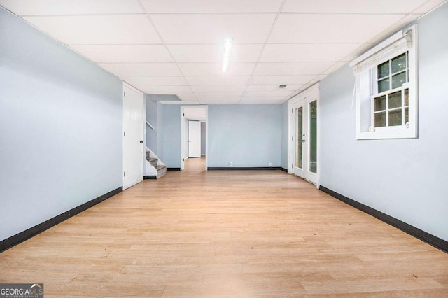 unfurnished room featuring a paneled ceiling and light hardwood / wood-style flooring