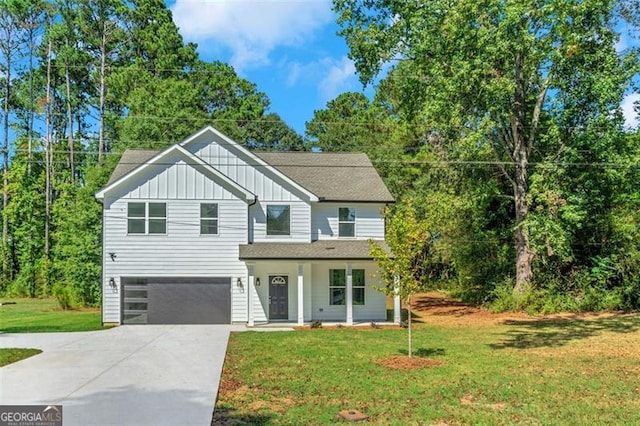 view of front of house featuring a porch, a garage, and a front yard