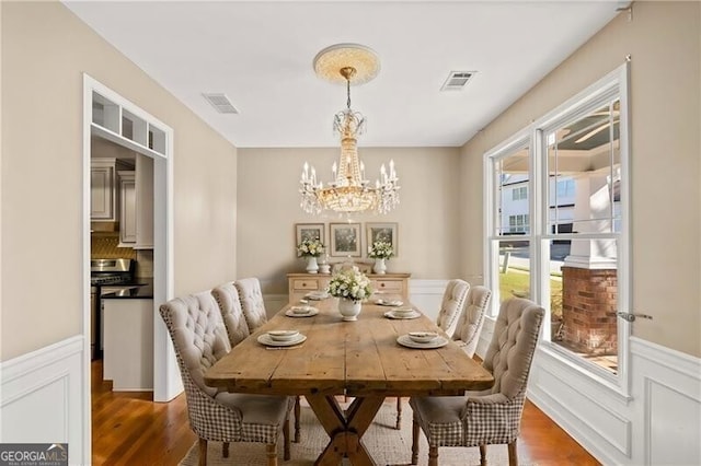 dining room featuring dark wood-type flooring and a chandelier