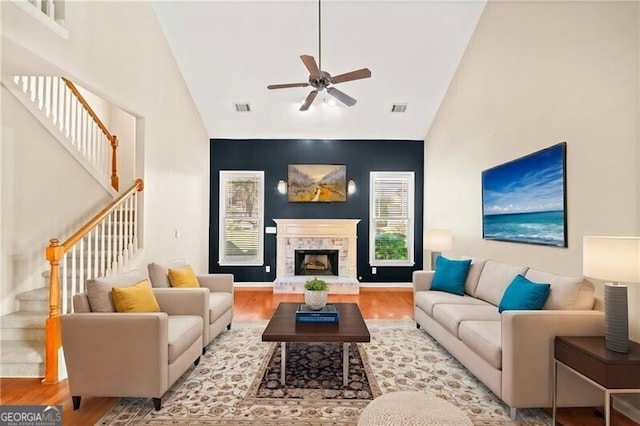 living room featuring light wood-type flooring, high vaulted ceiling, and ceiling fan