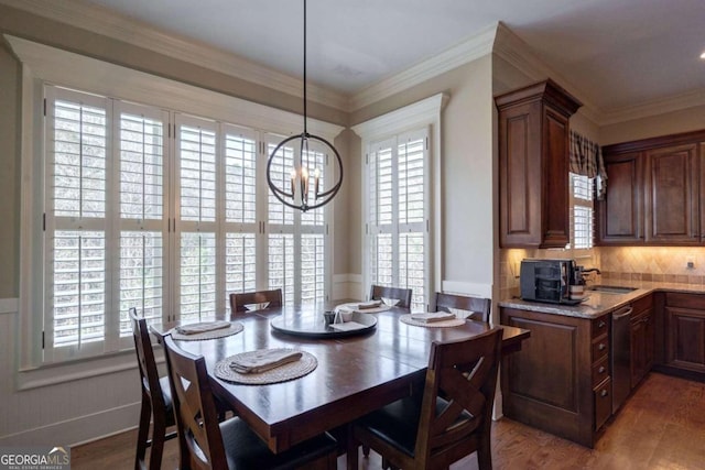 dining space featuring hardwood / wood-style floors, plenty of natural light, and ornamental molding