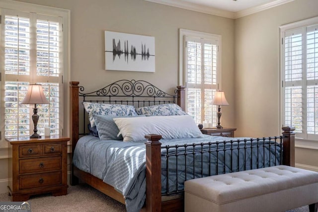 carpeted bedroom featuring multiple windows and crown molding