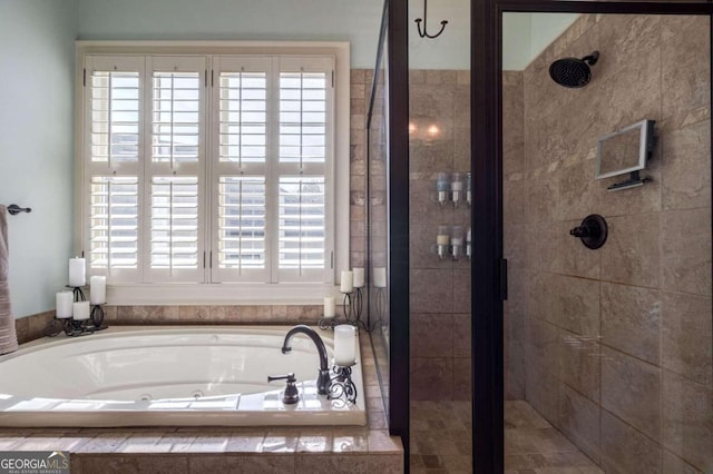 bathroom featuring a healthy amount of sunlight and shower with separate bathtub