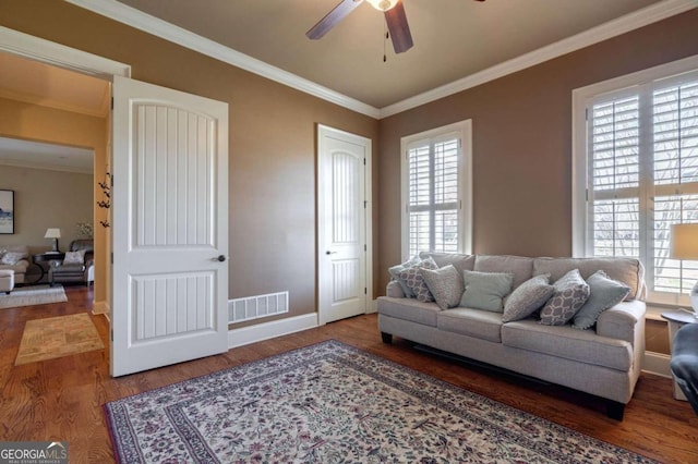 living room featuring wood-type flooring, ornamental molding, a healthy amount of sunlight, and ceiling fan