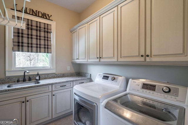 laundry area with separate washer and dryer, sink, light tile patterned floors, and cabinets